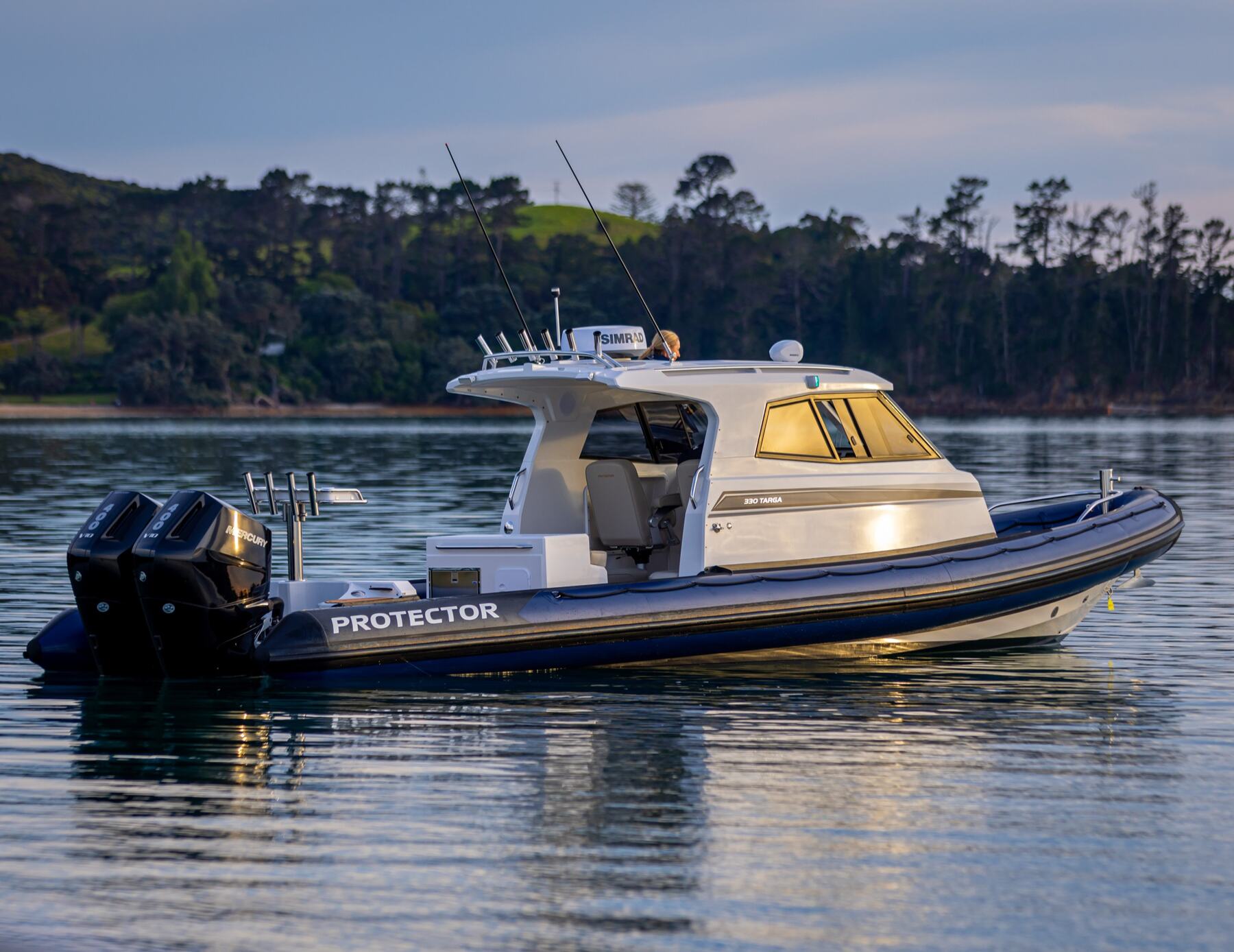 Protector 330R Targa running at speed on open water, twin Mercury Racing 400R V10 outboards at the stern
