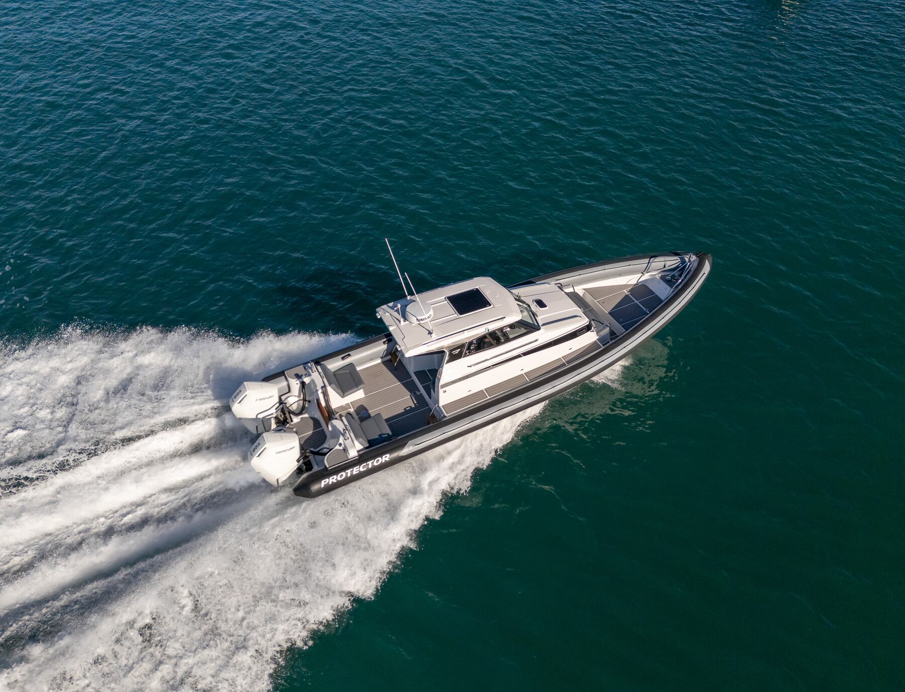 Protector 380 Targa running offshore at speed, enclosed cabin visible, low-angle action shot