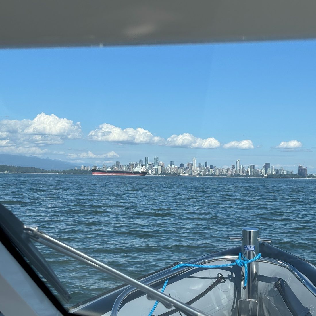 The Vancouver skyline seen across the water from the bow of a Protector