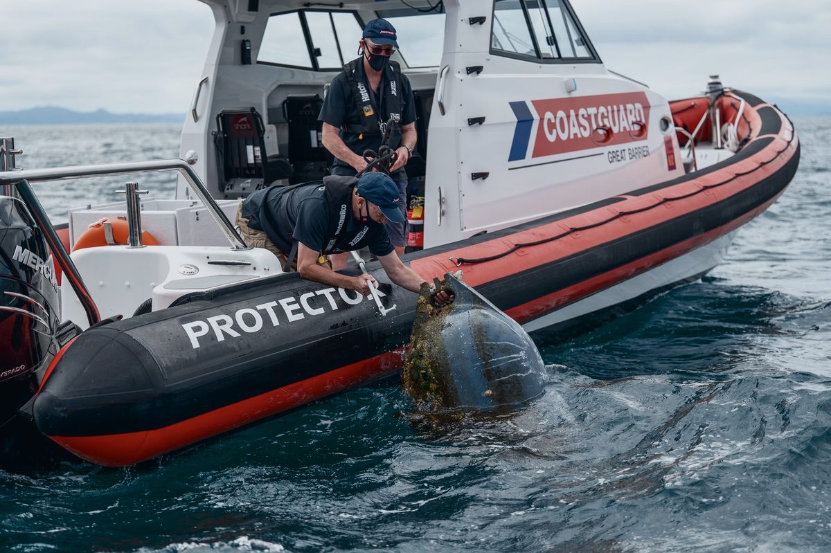 Crew aboard a Protector RIB in Coastguard livery