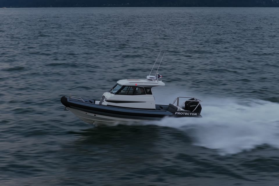 Protector Targa underway on calm water off the British Columbia coast at dusk