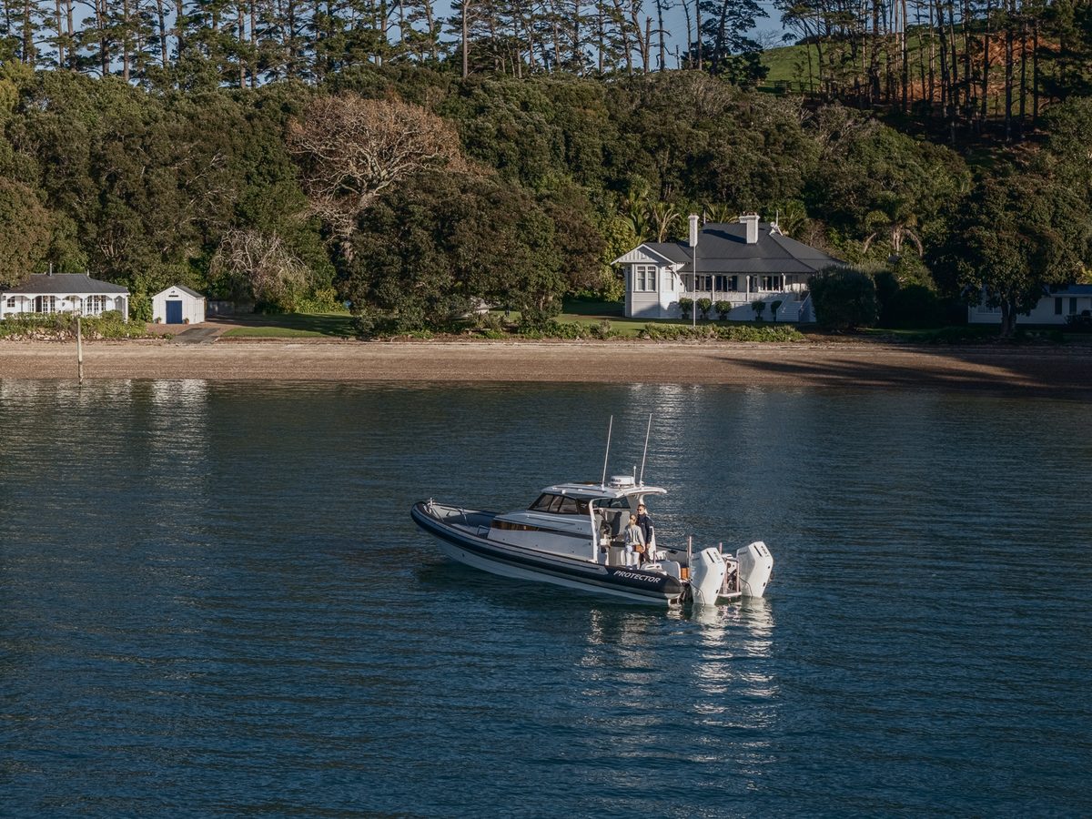 Protector 380 Targa enclosed-cabin tender at anchor off a beach